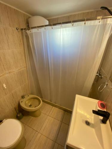 a bathroom with a toilet and a shower and a sink at Casa Uruguay in Piriápolis