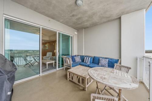 a living room with a blue couch and a table at Wharf 615 by Youngs Suncoast in Orange Beach