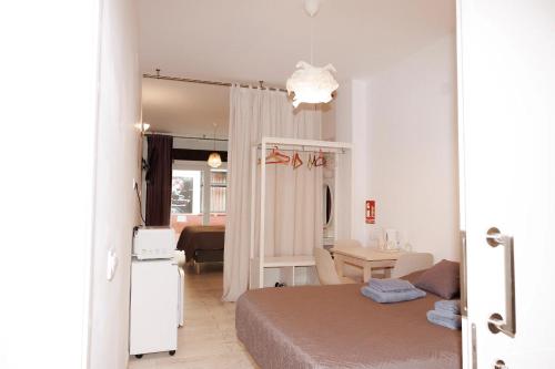a bedroom with a bed and a living room at Loft Valentia Ifach Calpe in Calpe
