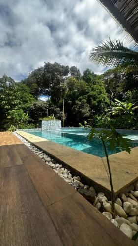 a swimming pool in the middle of a resort at Jeribucaçu bangalô in Itacaré