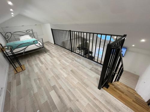 a room with a staircase and a bed in a room at Le loft sous les toits in Arles