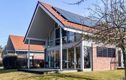 a house with a solar roof on top of it at Nice Home In Röbel With Sauna in Röbel