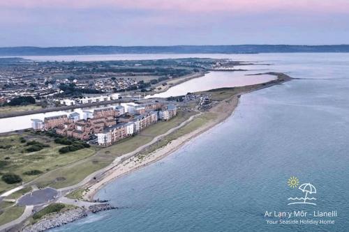 an aerial view of an island in the water at Ar Lan Y Mor - Stunning 2 bed coastal apartment in Llanelli