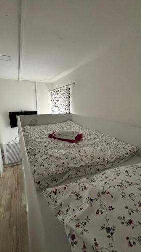 a bedroom with a bed with a blanket on it at Špeluňka in Luhačovice