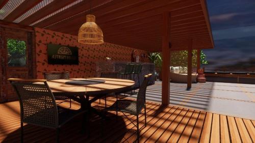 a patio with a table and chairs on a deck at Domo Geodesico de Luxo Astrum Vallis in Rio de Contas