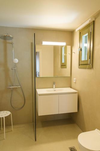a bathroom with a sink and a shower and a toilet at Villa Selina 7 - Etheras Properties in Kythira