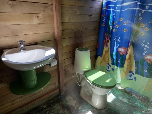 a bathroom with a sink and a toilet at Cabaña y restaurante vikana in Nuquí