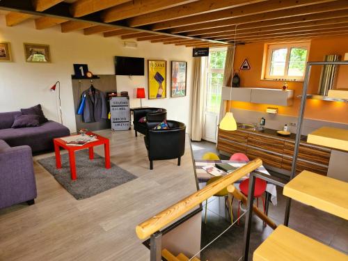 a living room with a couch and a table at Station Racour 'Magasin de la gare' in Landen
