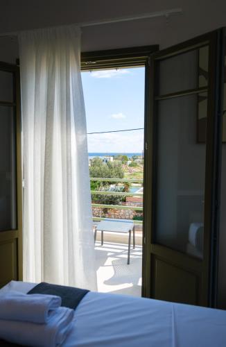 a bedroom with a bed and a window with a view at Villa Selina 7 - Etheras Properties in Kythira