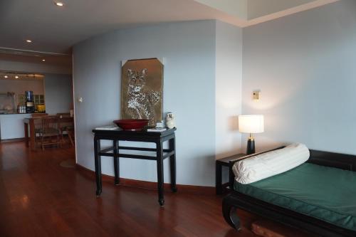 a room with a bed and a table with a bowl on it at Bayview Villa by AaskResidy in Patong Beach