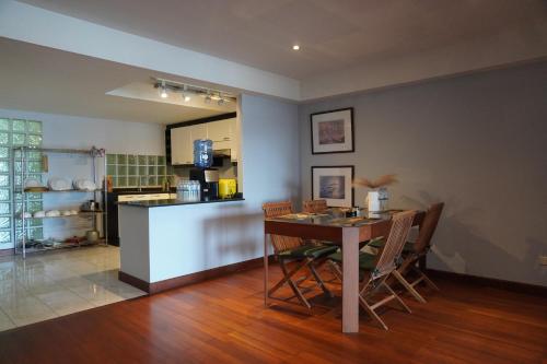 a kitchen and dining room with a table and chairs at Bayview Villa by AaskResidy in Patong Beach