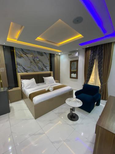 a hotel room with a bed and a chair at VHS Vinchee Suites II in Lagos