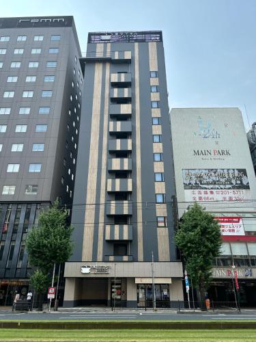 a large building with a sign on the side of it at Henn na Hotel Premier Kagoshima Tenmonkan in Kagoshima