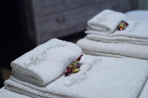 a pile of towels sitting on top of a table at Tiffany Rooms in Milan