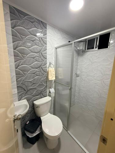 a bathroom with a toilet and a shower at Mini centrica suite privada con todo incluido in Loja