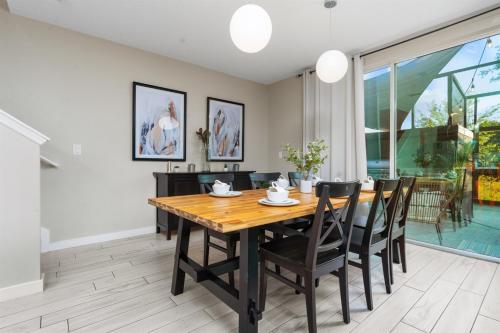 a dining room with a wooden table and chairs at Kid-Approved Stay Pool, Parks & Themed Rooms! in Kissimmee