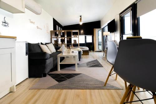 a living room with a couch and a table at The HIDE - Dreamland in Boldeşti-Scăeni