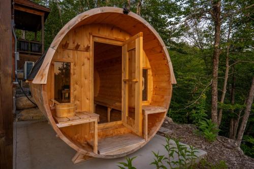 a large wooden hobbit house in the woods at Epic Views, 9Mi SR, GameRmTheater, HTub, Sauna in Bethel