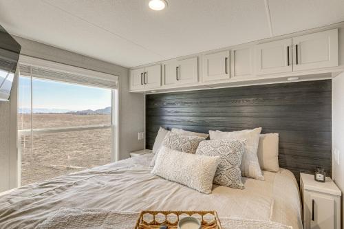 a bedroom with a large bed with a wooden headboard at "Cozy Montana" Home w/ Mountain Views! in Kalispell