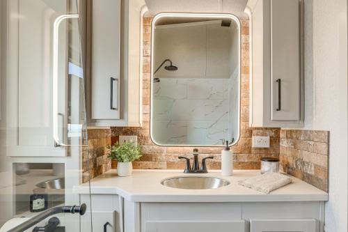 a bathroom with a sink and a mirror at "Cozy Montana" Home w/ Mountain Views! in Kalispell