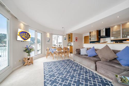 a living room with a couch and a table at No 21 The Salcombe in Salcombe
