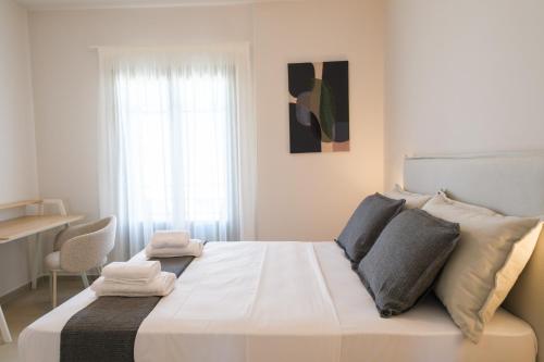 a bedroom with a large white bed with a window at Villa Selina 8 - Etheras Properties in Kythira