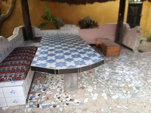 a table in a room with a tile floor at Chez Aicha Ndangane in Ndangane