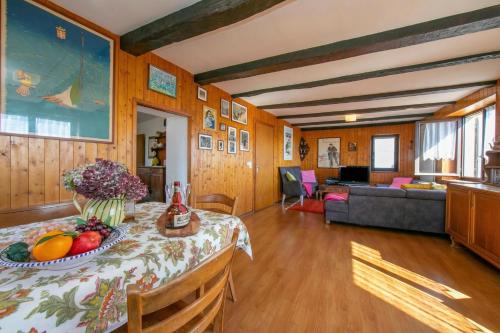 a living room with a table with fruit on it at Chalet Cademario Lake-View 3BR Duplex - Happy Rentals in Cademario