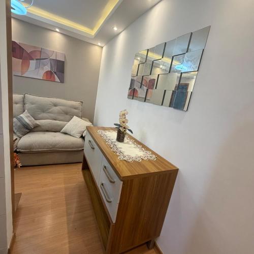 a living room with a couch and a table at Apartamento completo e confortável em Duque de Caxias in Duque de Caxias