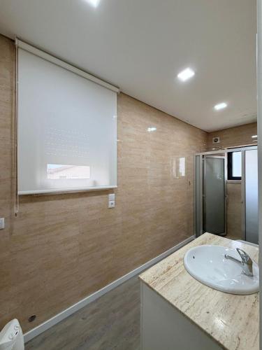 a bathroom with a sink and a projection screen at Dream House in Aldeia Nova