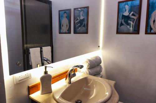 a bathroom with a sink and a mirror and towels at Chalé de montaña con Jacuzzi in Guarne