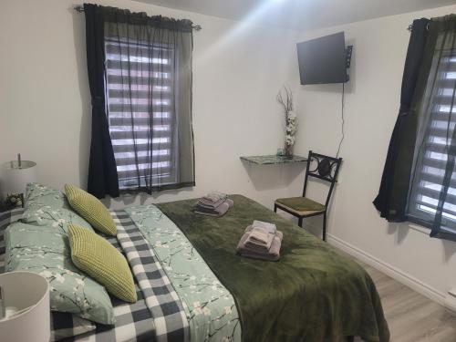a bedroom with a bed with two towels on it at Downtown apartment next to highway netflix+wifi in Edmundston