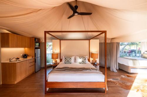 a bedroom with a canopy bed in a tent at Ingenia Holidays Rivershore in Maroochydore