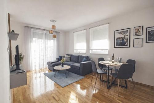 a living room with a couch and two tables at Apartman River in Bijeljina
