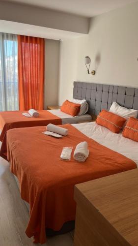 two beds in a hotel room with towels on them at Ramona Lara in Antalya