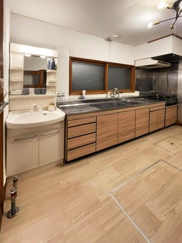 a large kitchen with a sink and a counter top at 呼人2 Arun別邸 in Abashiri