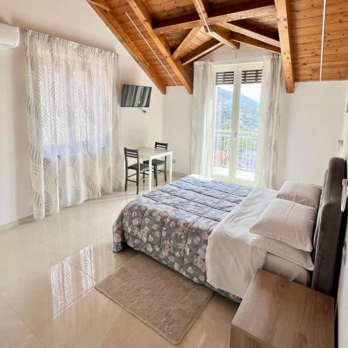 a bedroom with a bed and a table and chairs at La Villa Carmelina in Agerola
