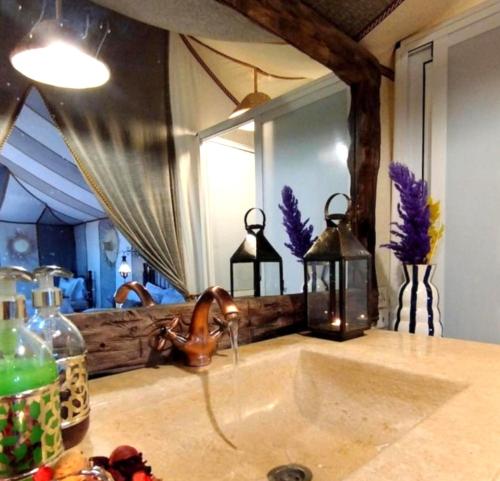 a sink in a bathroom with a large mirror at Starry Nights Camp in Merzouga