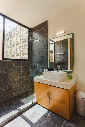 a bathroom with a sink and a shower at Luxurious 2Br 2 5 Ba in Residential Neighborhood in Mérida