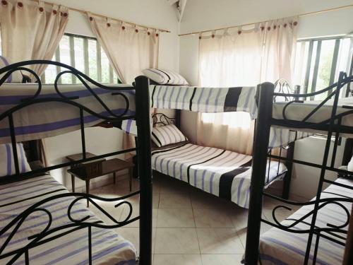 a dorm room with three bunk beds in it at Alborada Chinauta in La Serena