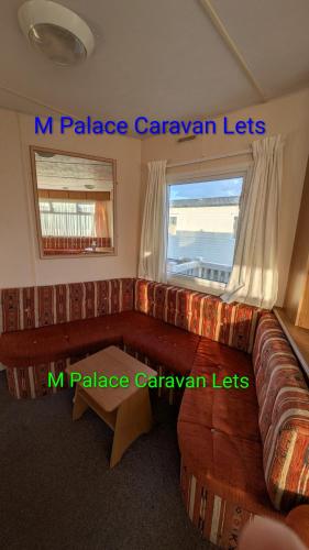 a living room with a couch and a window at R6 North Shore Holiday Park in Winthorpe