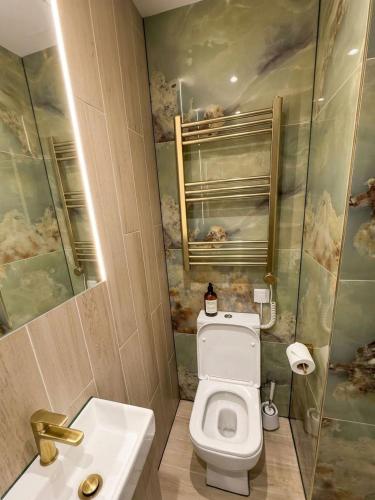 a bathroom with a toilet and a sink at 30C The Luxury Studios near Arsenal and Central London in London