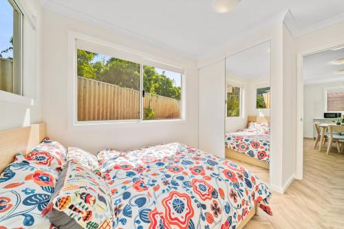 a bedroom with two beds and a window at Modern Family Home Near Fiona Stanley & Murdoch Uni in Perth