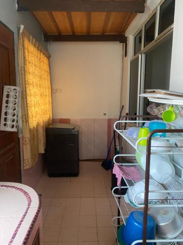 a kitchen with a dish drying rack with dishes at Best Homestay in Kuala Rompin