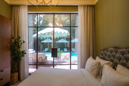 a bedroom with a bed and a view of a patio at Boutique Residence Villa Atouta-Lemon Spaces Maadi in Cairo