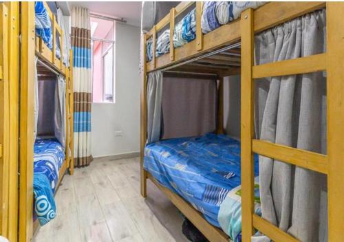 two bunk beds in a room with a room with at Mariandes Hostel in Huaraz