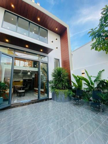 a house with glass doors and a patio at Bhome in Vung Tau