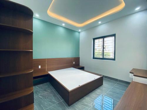 a room with a bed and a window at Bhome in Vung Tau