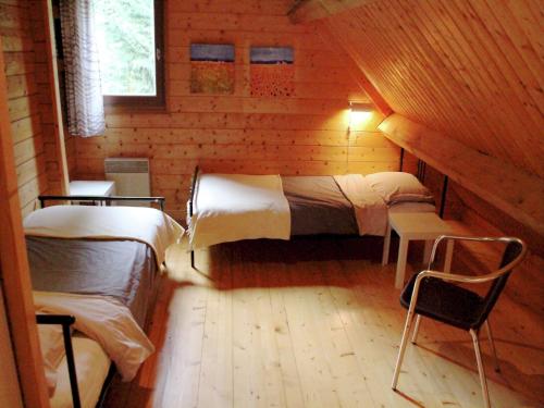 a bedroom with two beds in a wooden cabin at Poolside Bliss Near Lake in Beaulieu
