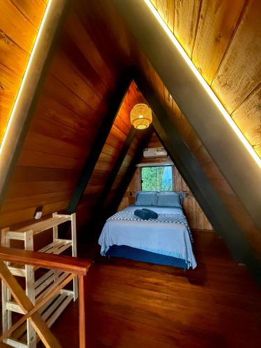 a bedroom with a bed in a attic at Nature Senses Chapadinha in Cavalcante